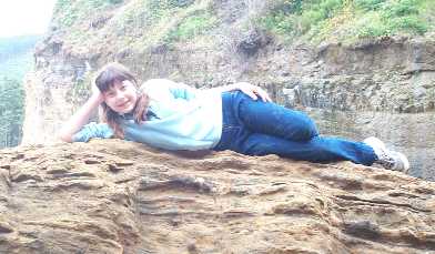 Jill on a rock on the beach
